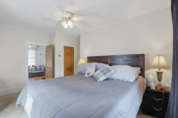 a bedroom with a bed and a lamp