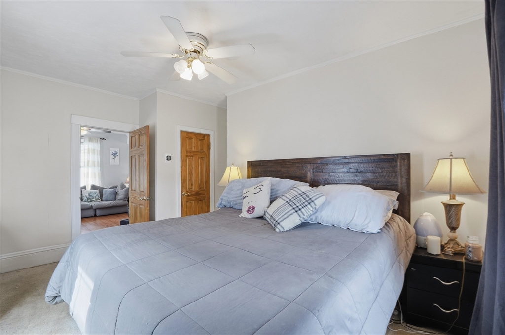 203 South Main Street Acushnet, MA 02743 - Photo 18 of 34 a bedroom with a bed and a lamp