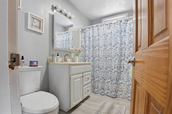 a bathroom with a toilet sink and vanity