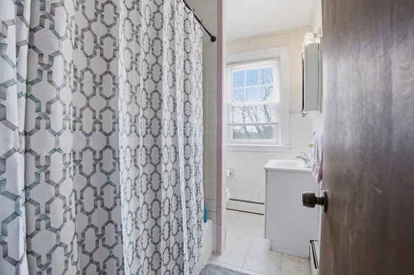 a bathroom with a shower curtain and a sink