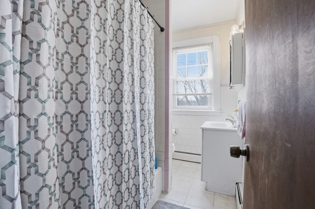 203 South Main Street Acushnet, MA 02743 - Photo 28 of 34 a bathroom with a shower curtain and a sink
