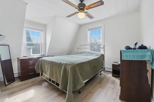 a bedroom with a bed dresser and a window