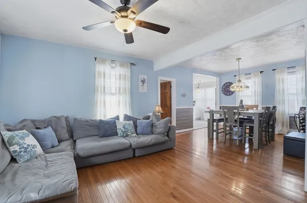 a living room with furniture and wooden floor