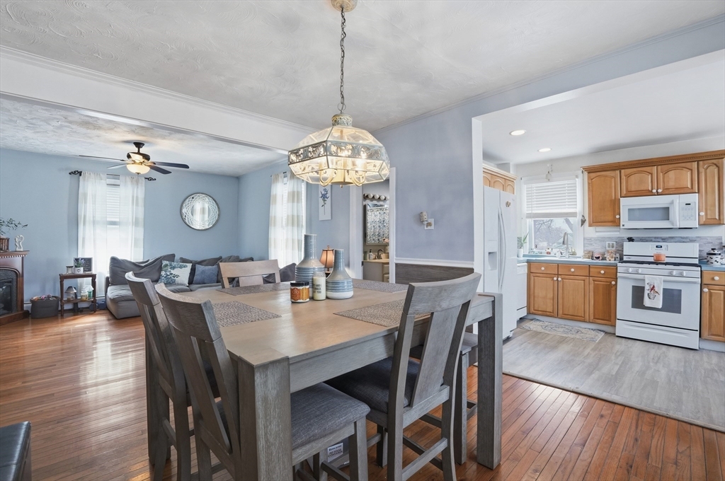 203 South Main Street Acushnet, MA 02743 - Photo 9 of 34 a view of a dining room and a kitchen with a table chairs