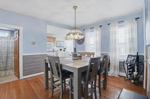 a view of a dining room with furniture window and wooden floor