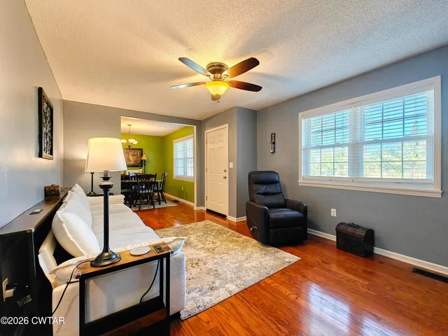 a living room with furniture and wooden floor