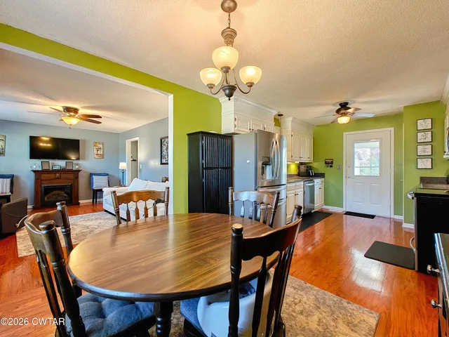 a view of a dining room with furniture and a chandelier