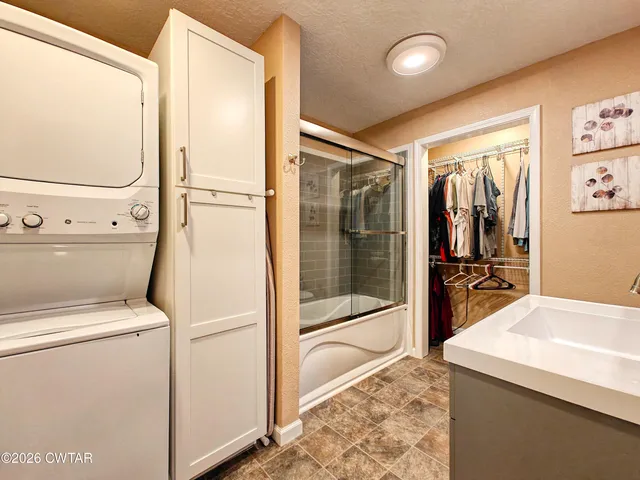 a bathroom with a sink toilet and shower a mirror
