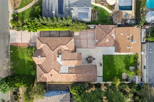 an aerial view of a house with a yard and plants