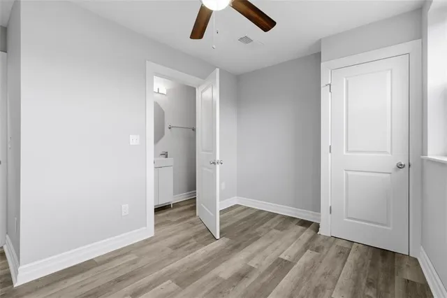 an empty room with closet and wooden floor