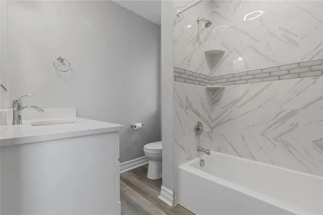 a bathroom with a sink a toilet and bathtub