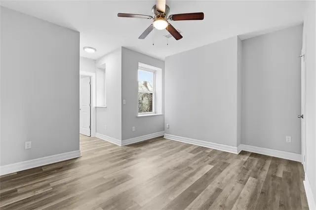 wooden floor in an empty room with a window