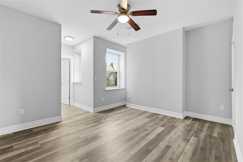 714 Cherokee Street Pittsburgh, PA 15219 - Photo 20 of 26 wooden floor in an empty room with a window
