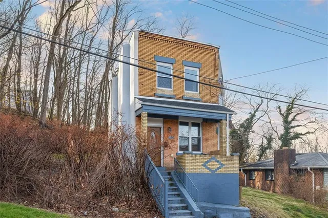 a view of a house with a wooden fence