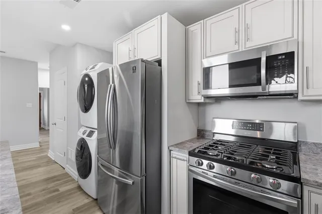 a kitchen with stainless steel appliances granite countertop a stove and a refrigerator