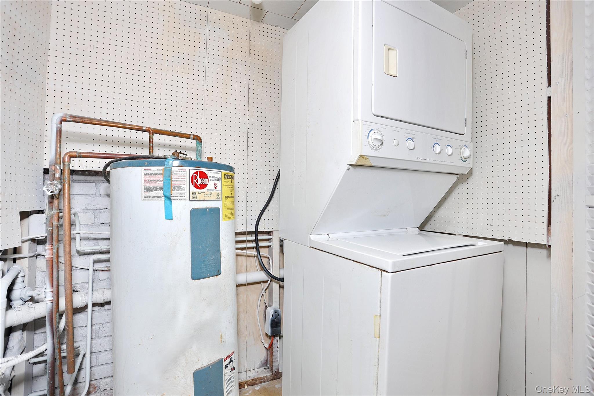 84 Pine Hill Road Chester, NY 10918 - Photo 15 of 18 Laundry area featuring water heater and stacked washer / dryer
