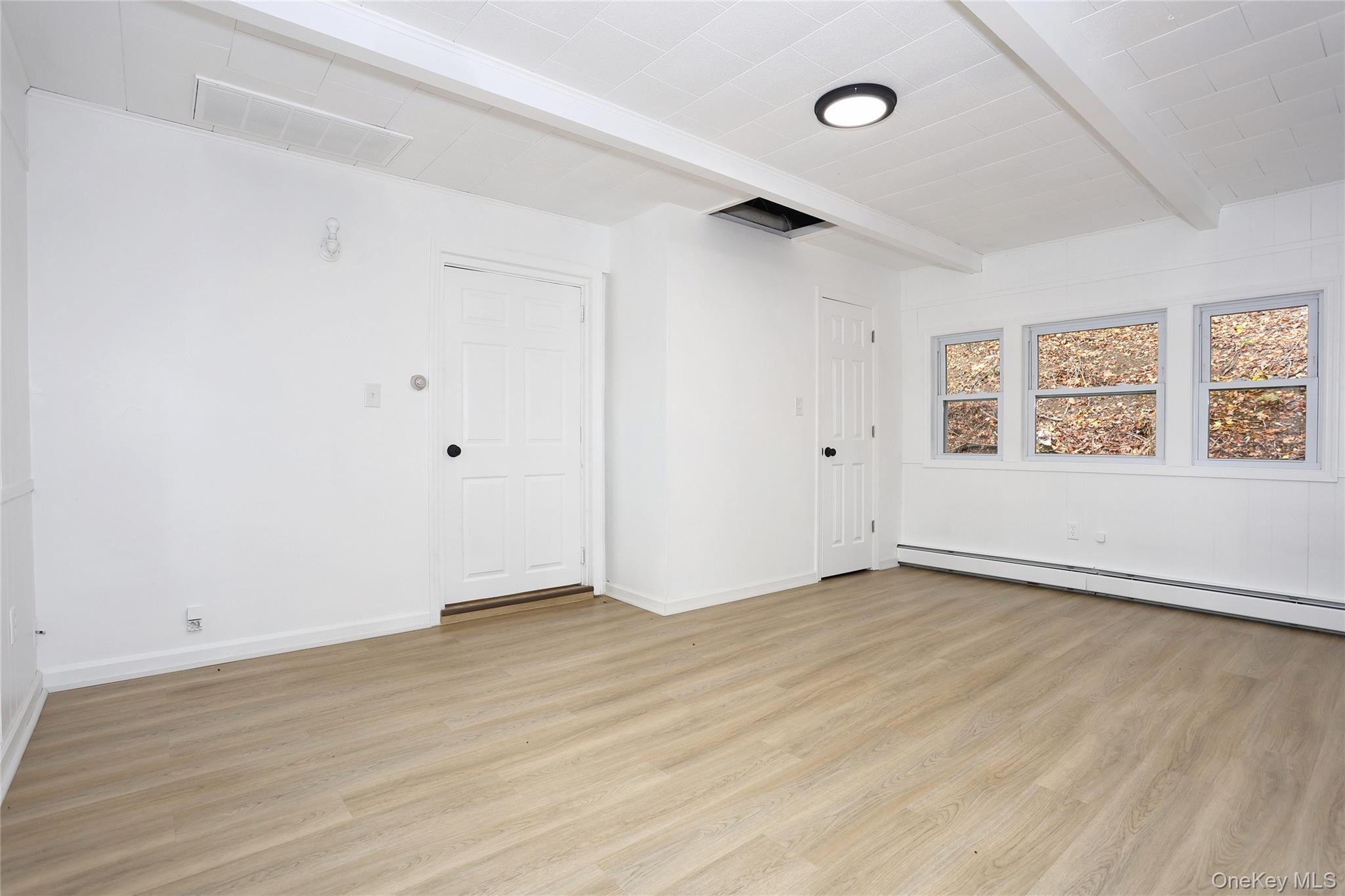 84 Pine Hill Road Chester, NY 10918 - Photo 17 of 18 Bedroom-3 featuring beamed ceiling, light wood-style floors, and a baseboard heating unit
