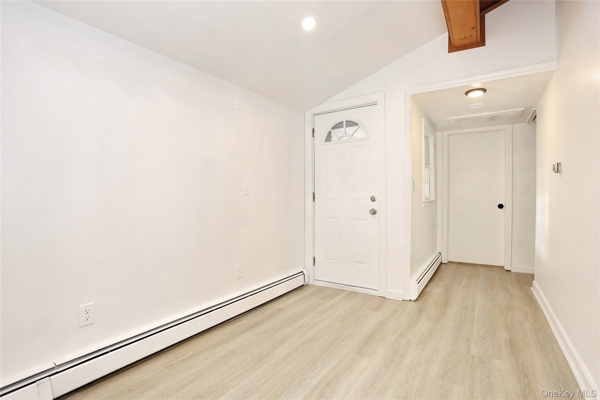 84 Pine Hill Road Chester, NY 10918 - Photo 8 of 18 Empty room with baseboard heating, vaulted ceiling, light wood-style floors, and recessed lighting