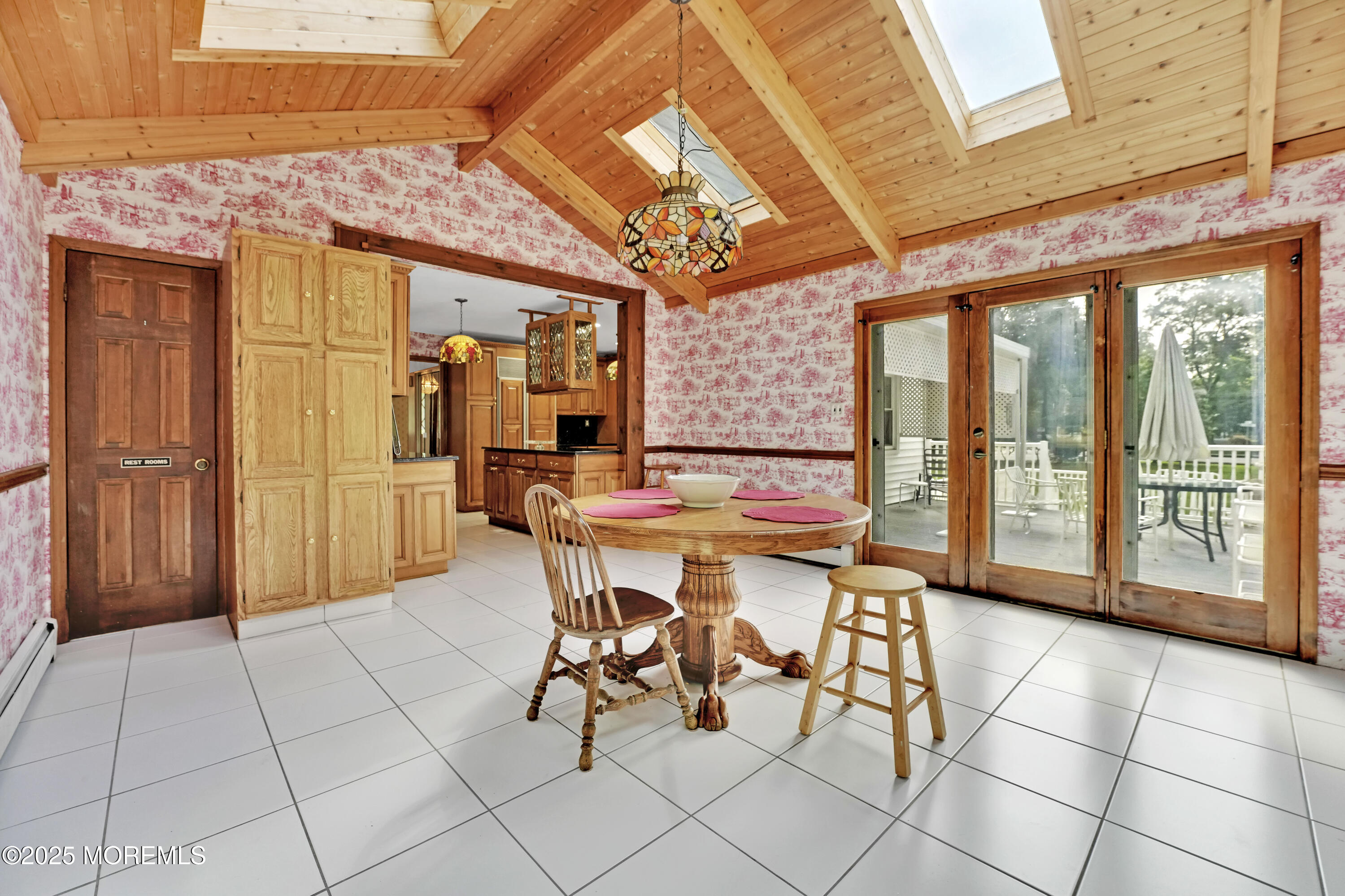 32 Woods Road Freehold, NJ 07728 - Photo 12 of 35 a dining room with furniture and a chandelier
