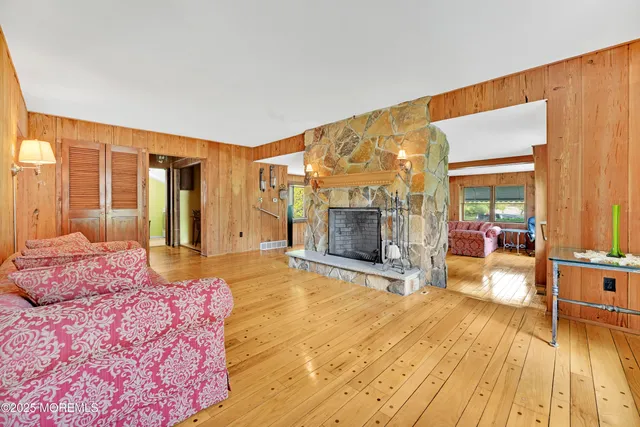 a spacious bedroom with a bed and wooden floor