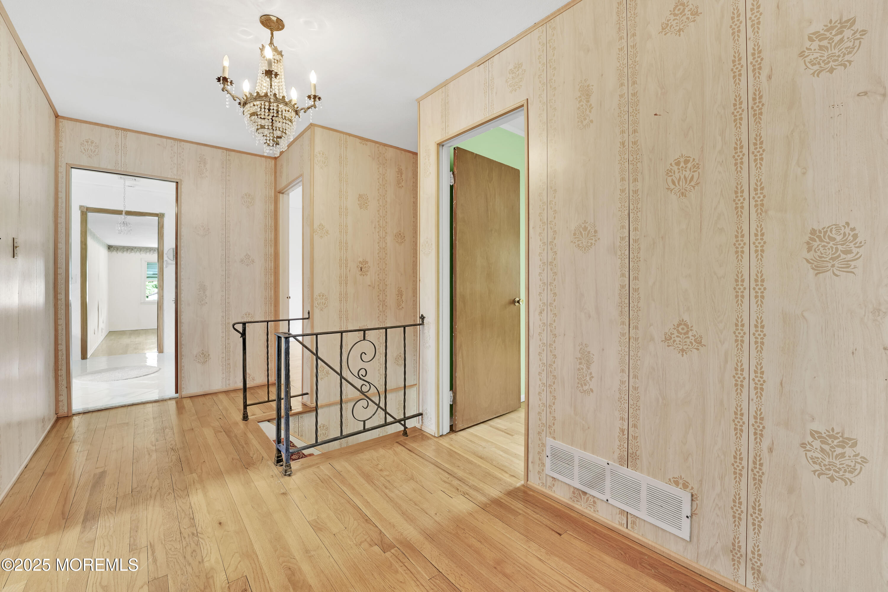 32 Woods Road Freehold, NJ 07728 - Photo 16 of 35 a view of a hallway with wooden floor and staircase