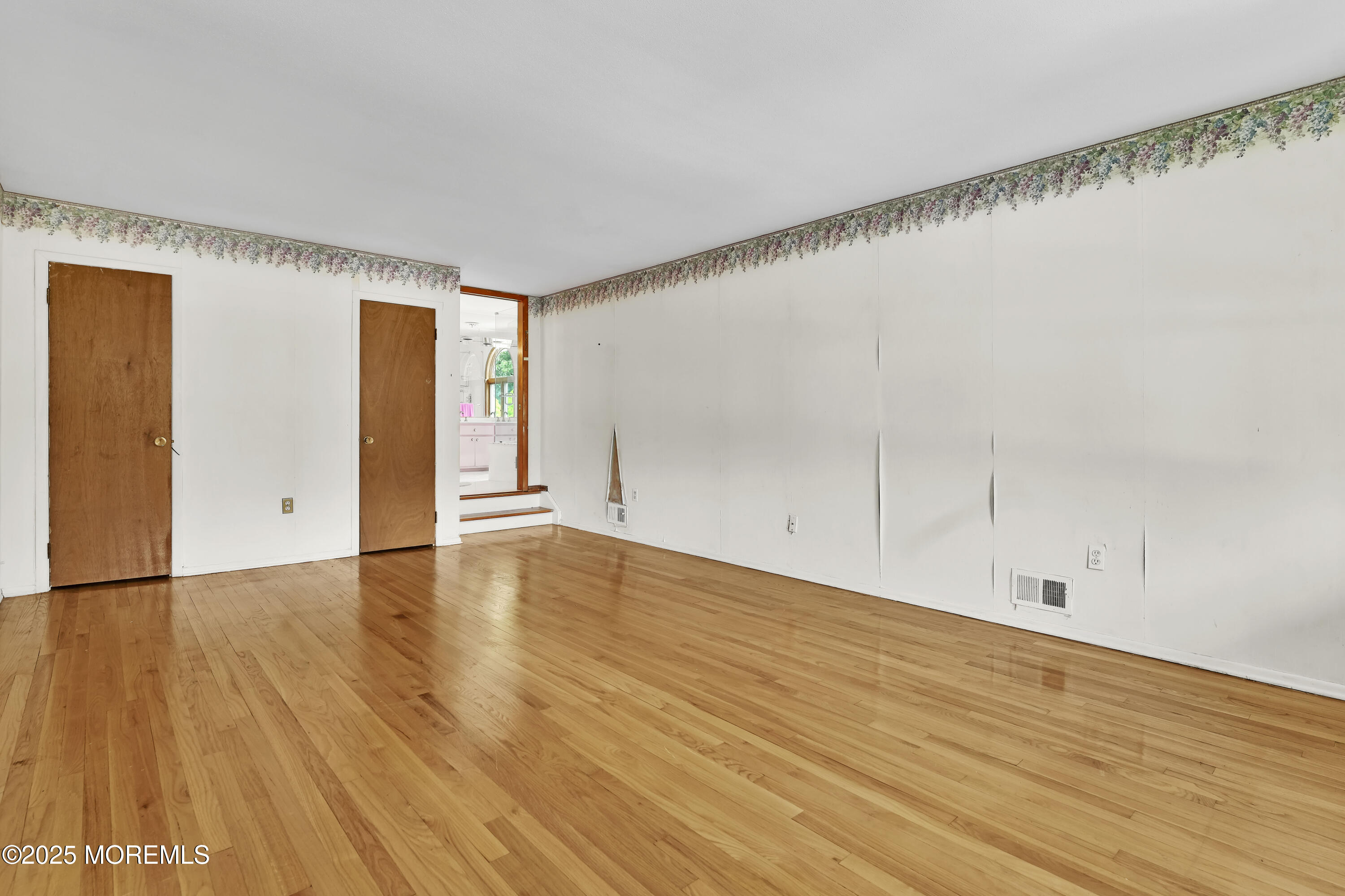 32 Woods Road Freehold, NJ 07728 - Photo 19 of 35 a view of an empty room with wooden floor