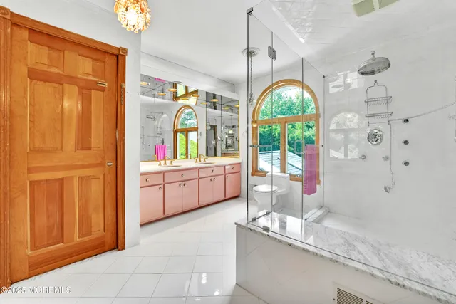 a kitchen with stainless steel appliances granite countertop a sink a counter space and a window