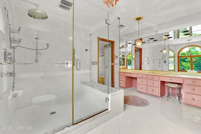 a large bathroom with a tub sink and mirror