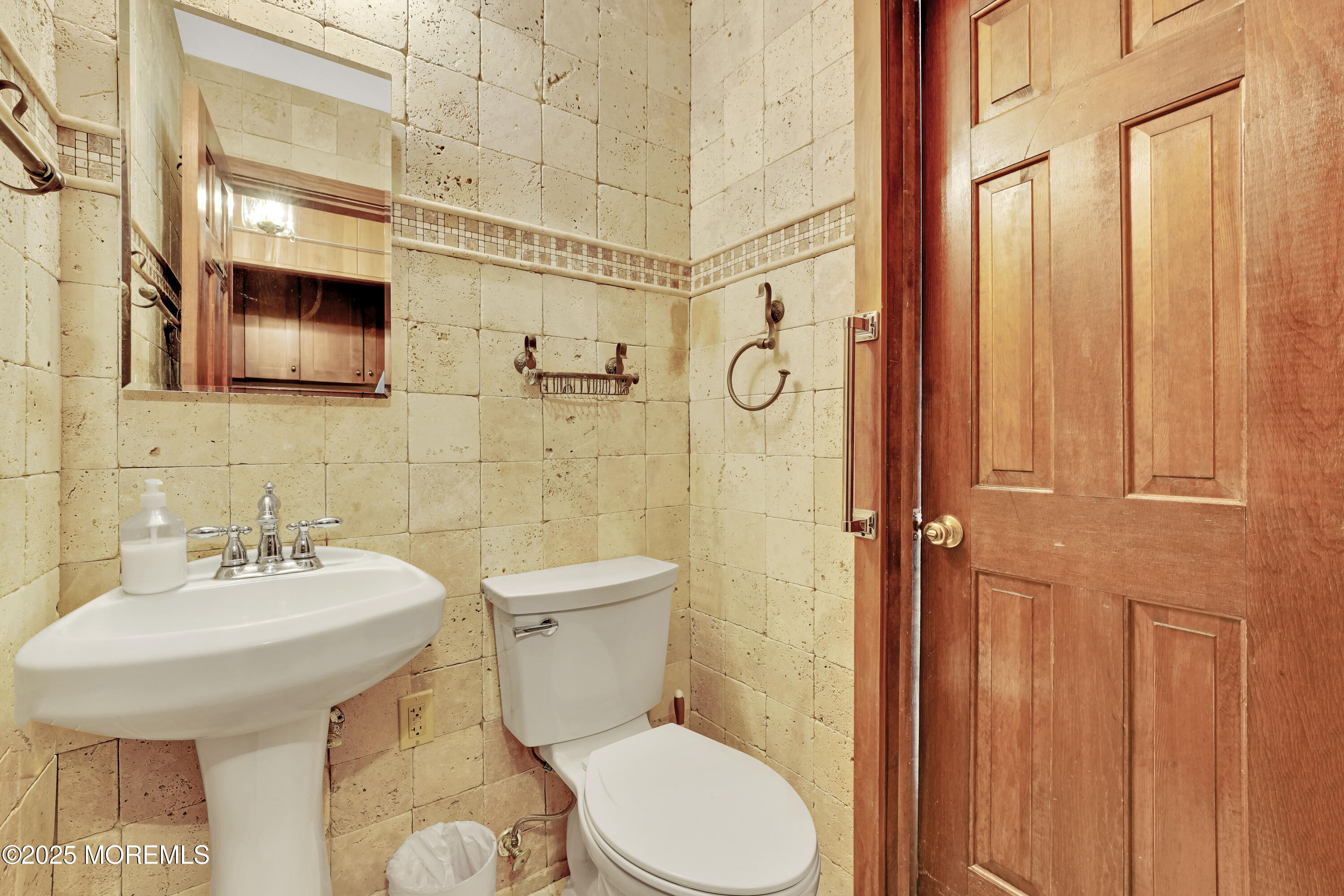 32 Woods Road Freehold, NJ 07728 - Photo 31 of 35 a bathroom with a sink a toilet and shower curtain