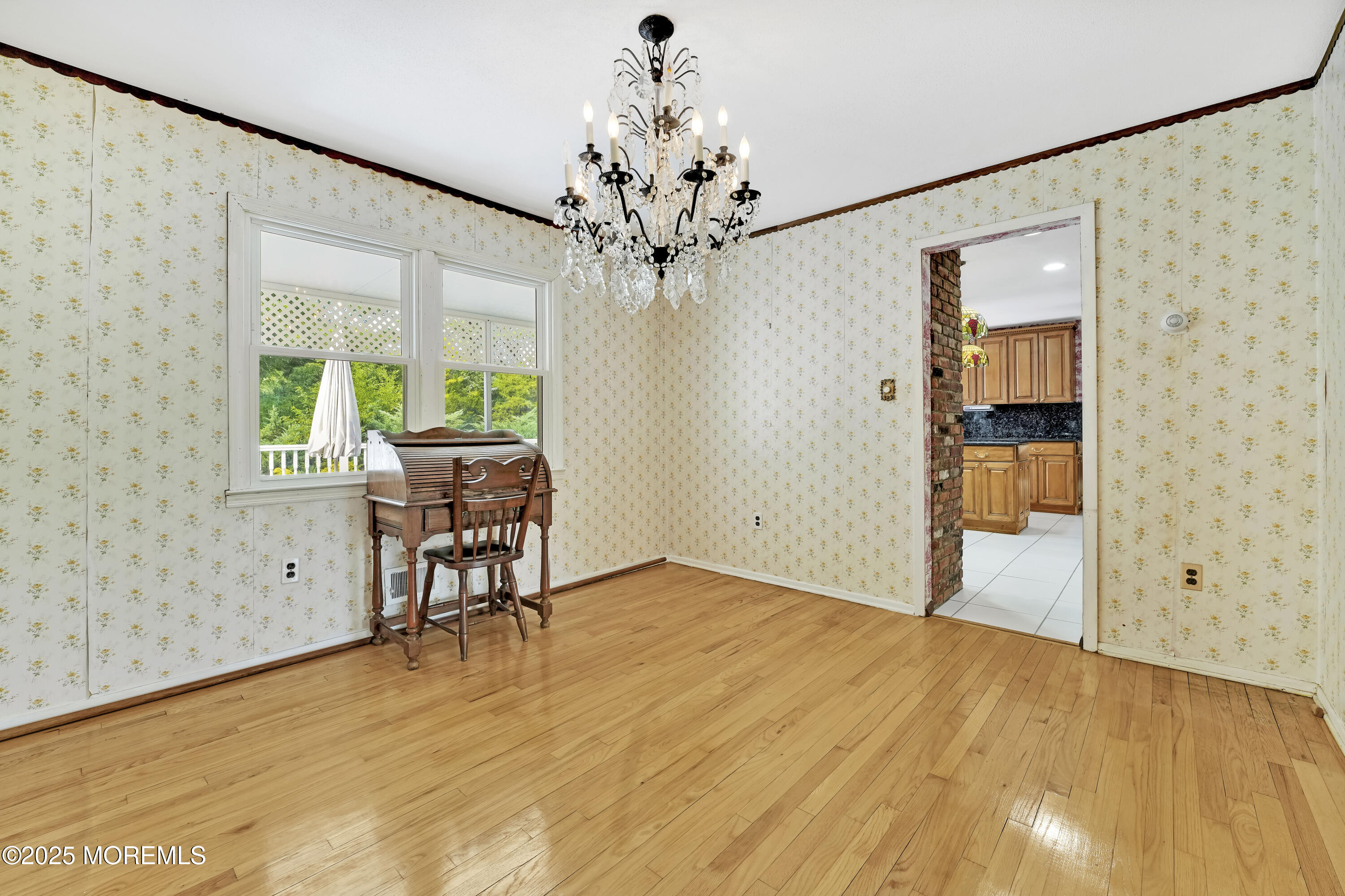 32 Woods Road Freehold, NJ 07728 - Photo 7 of 35 a view of an empty room with a window and wooden floor