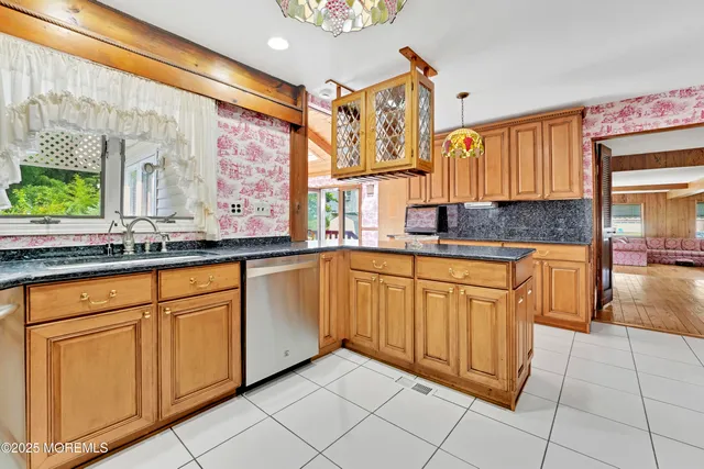 a kitchen with stainless steel appliances granite countertop a sink and cabinets