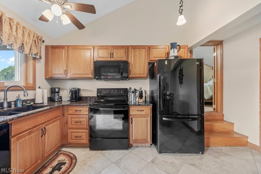 6939 Lakeview Road Hanoverton, OH 44423 - Photo 10 of 42 Kitchen featuring black appliances, light cermaic tile floors, sink, and ceiling fan