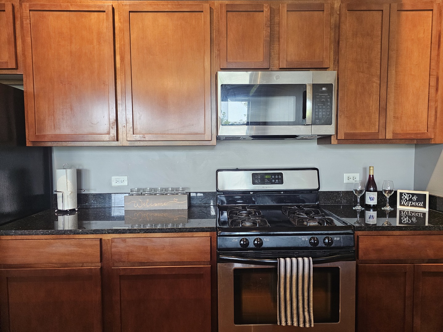 2323 West Pershing Road, Unit 230 Chicago, IL 60609 - Photo 16 of 30 a kitchen with stainless steel appliances granite countertop a stove a sink and a microwave