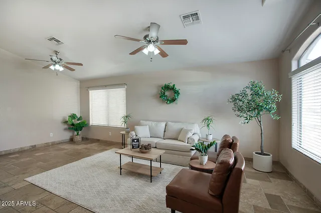a living room with furniture and a large window