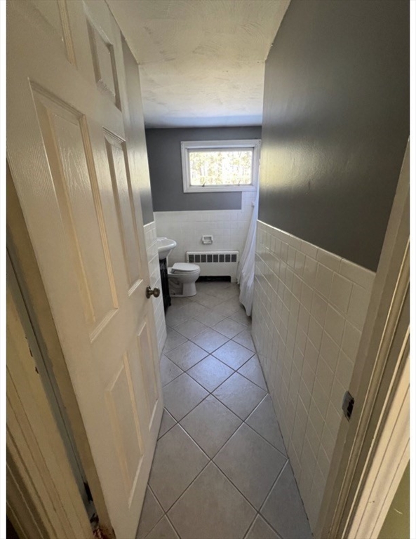 7 Butler Road Wilbraham, MA 01095 - Photo 8 of 9 a view of an empty room with wooden floor and a window