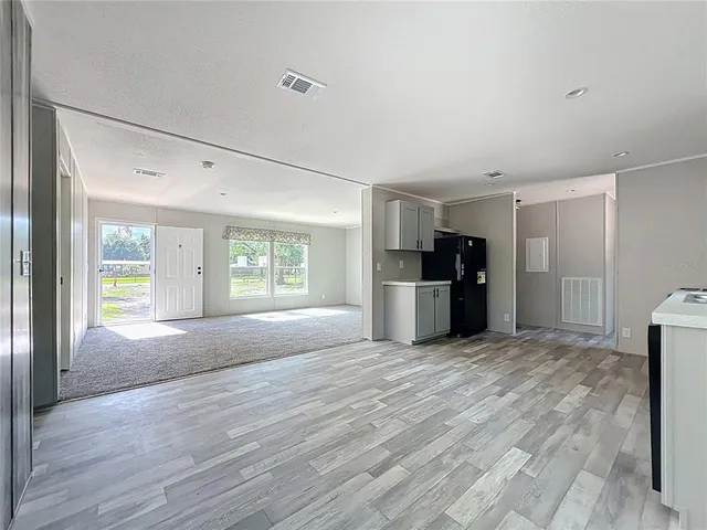 a kitchen with stainless steel appliances a stove a sink and wooden cabinets