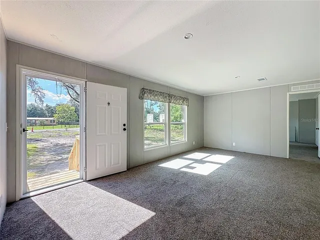 a kitchen with granite countertop a refrigerator stove top oven and sink
