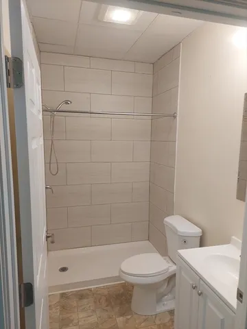 a bathroom with a toilet and shower