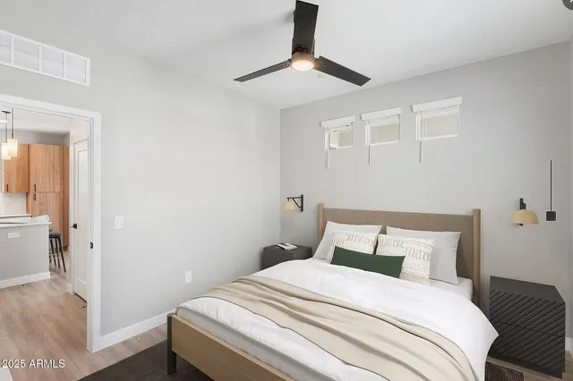 a bedroom with a bed and a chandelier