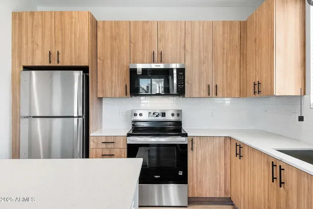 a kitchen with appliances and cabinets