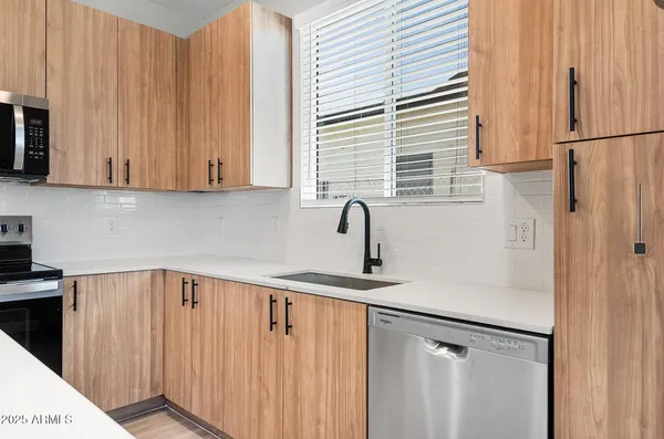 a kitchen with a refrigerator and cabinets