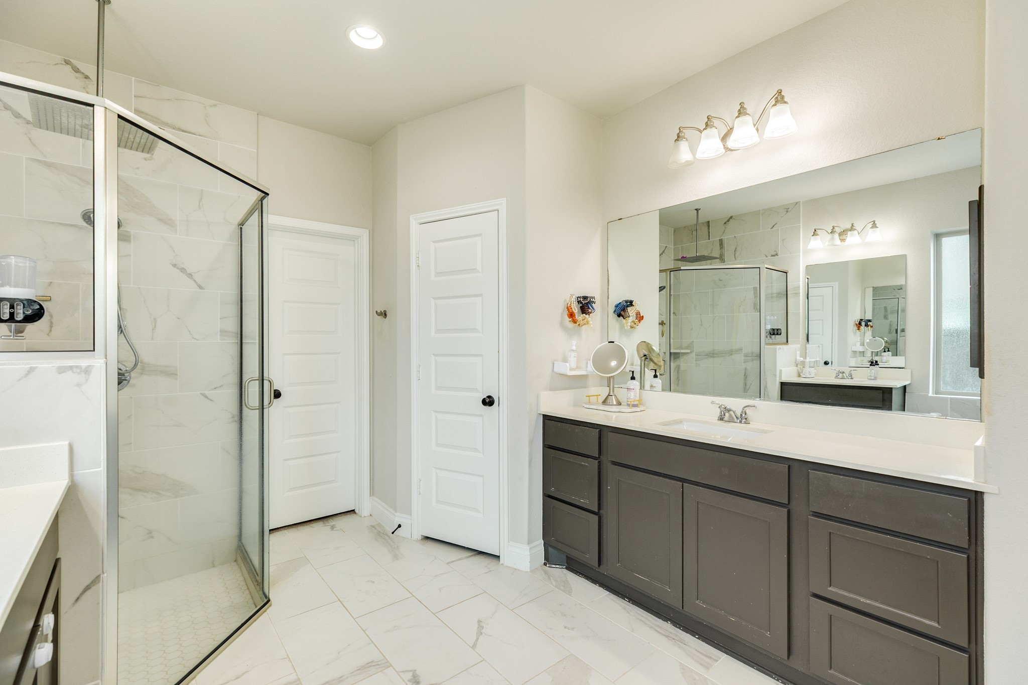 3706 Arpa Street Rosharon, TX 77583 - Photo 21 of 50 a spacious bathroom with a shower sink and mirror