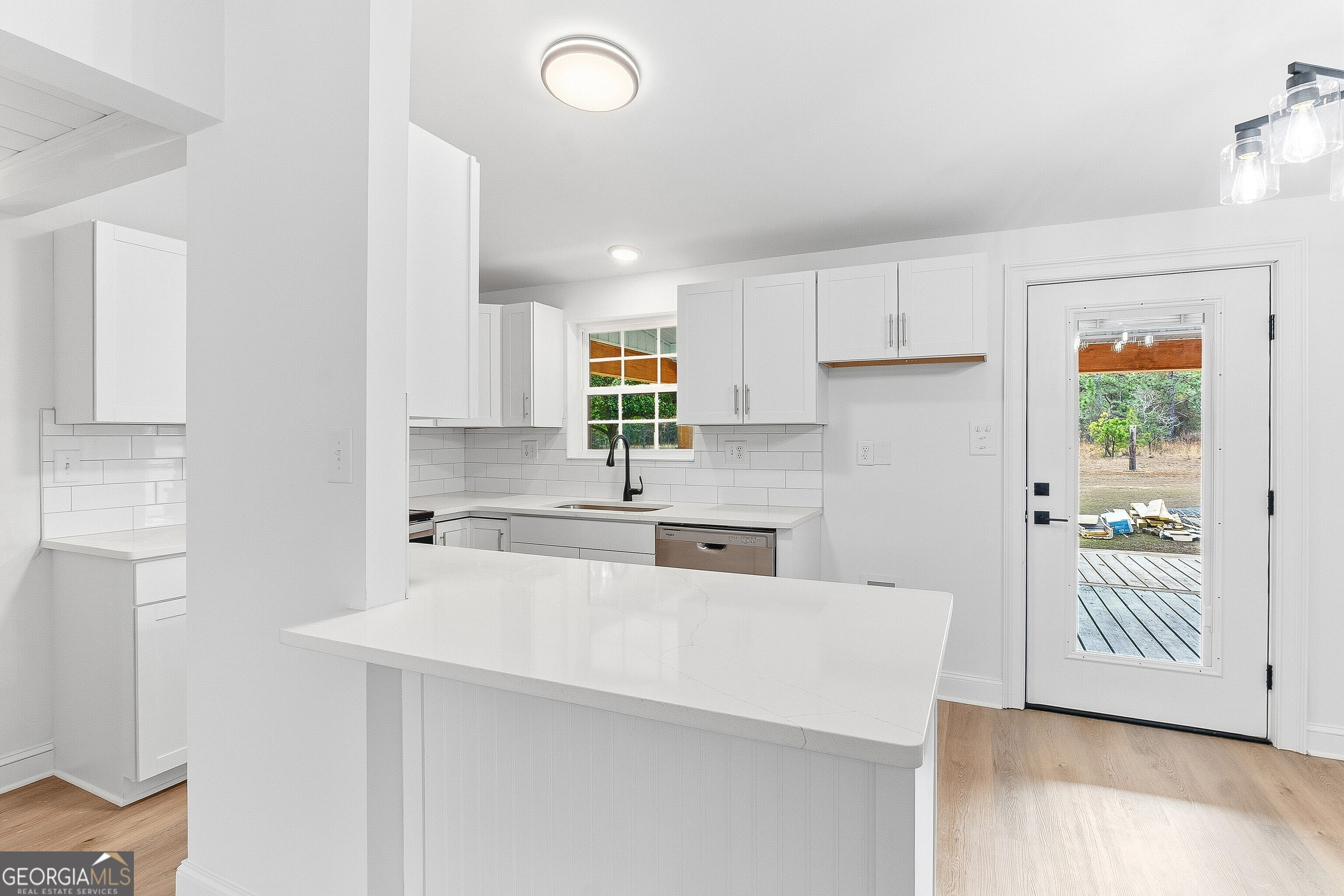 5393 Rogers Road Lizella, GA 31052 - Photo 12 of 52 a kitchen with a sink a stove and cabinets