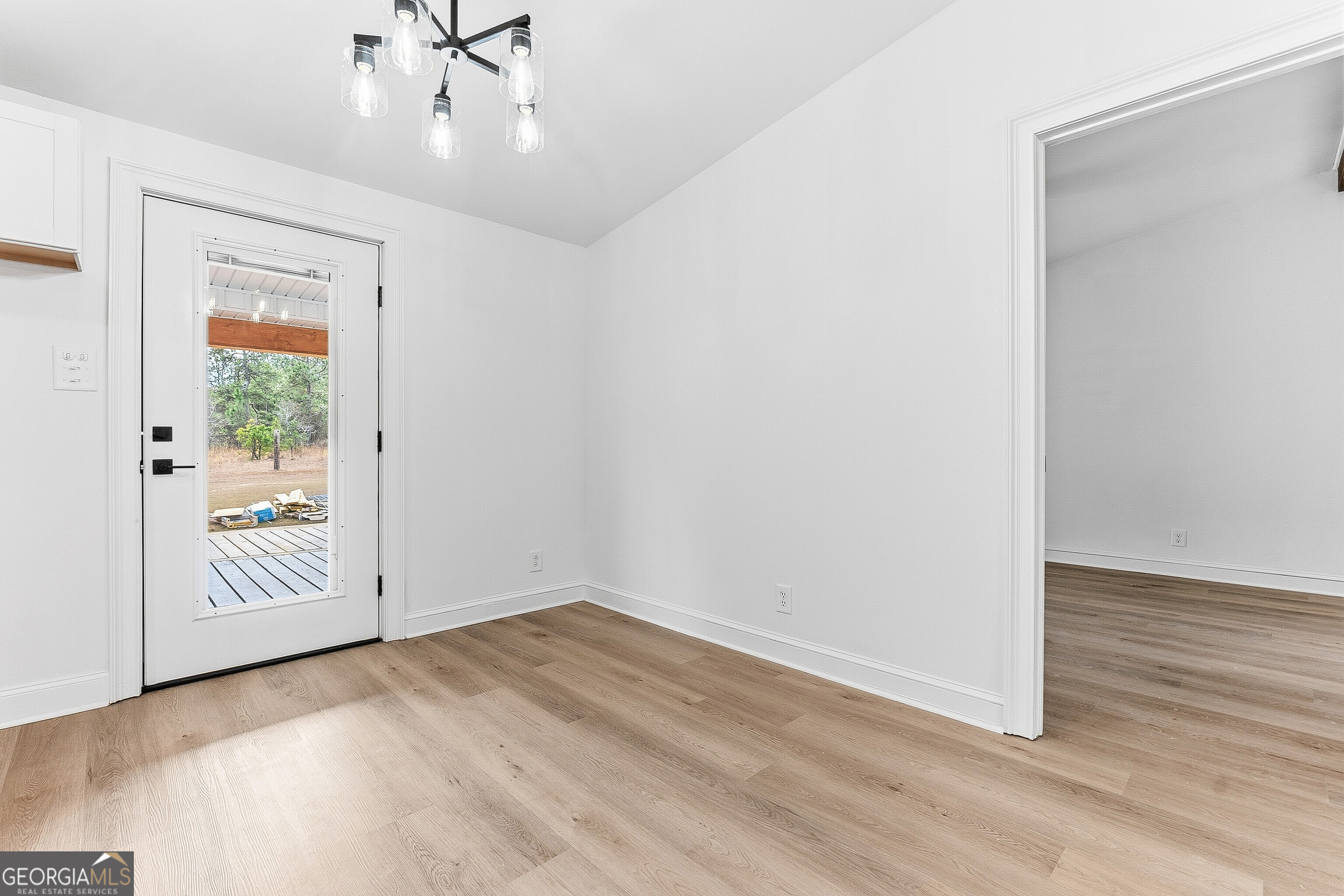 5393 Rogers Road Lizella, GA 31052 - Photo 14 of 52 an empty room with wooden floor mirror and windows