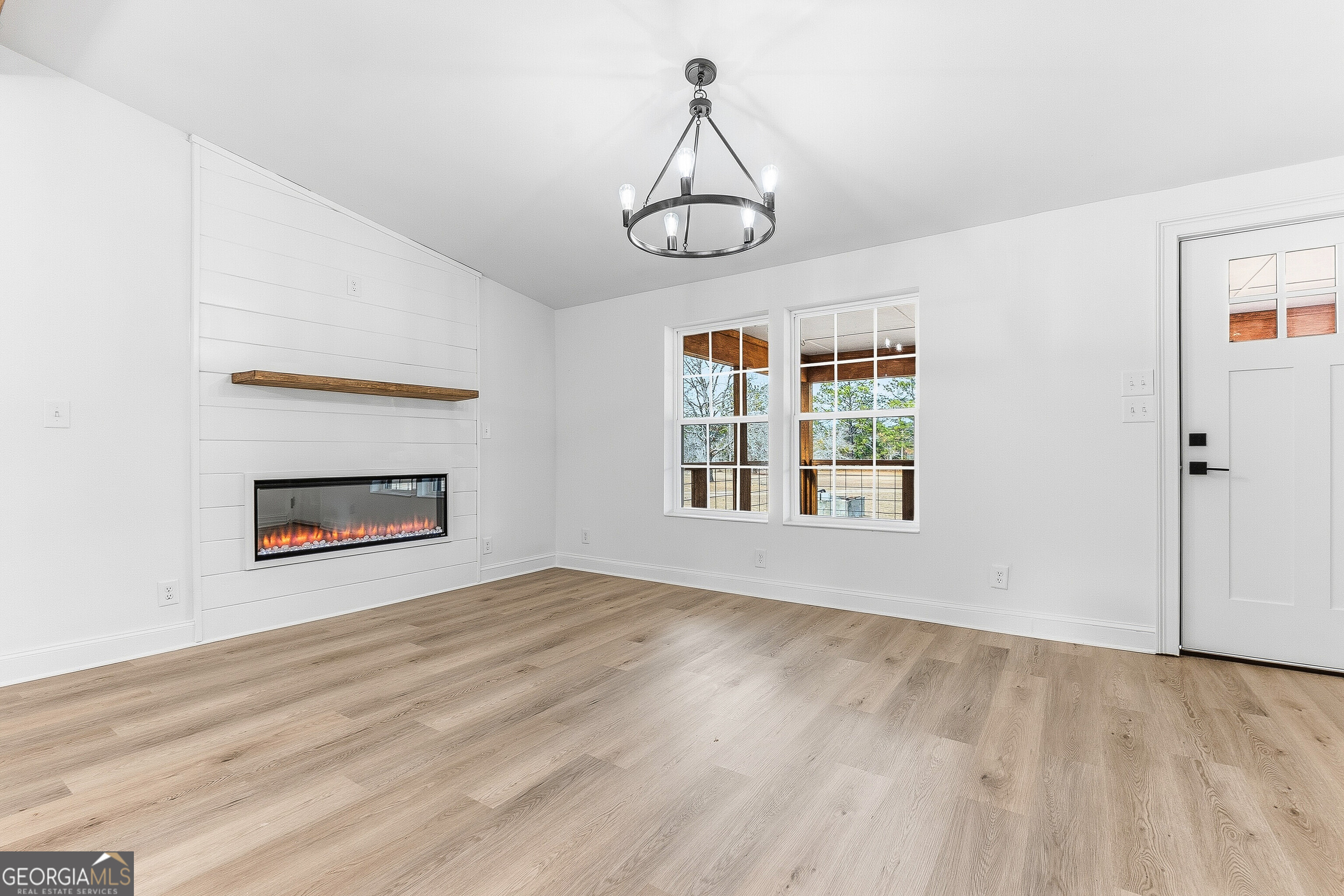 5393 Rogers Road Lizella, GA 31052 - Photo 18 of 52 an empty room with wooden floor cabinet and windows