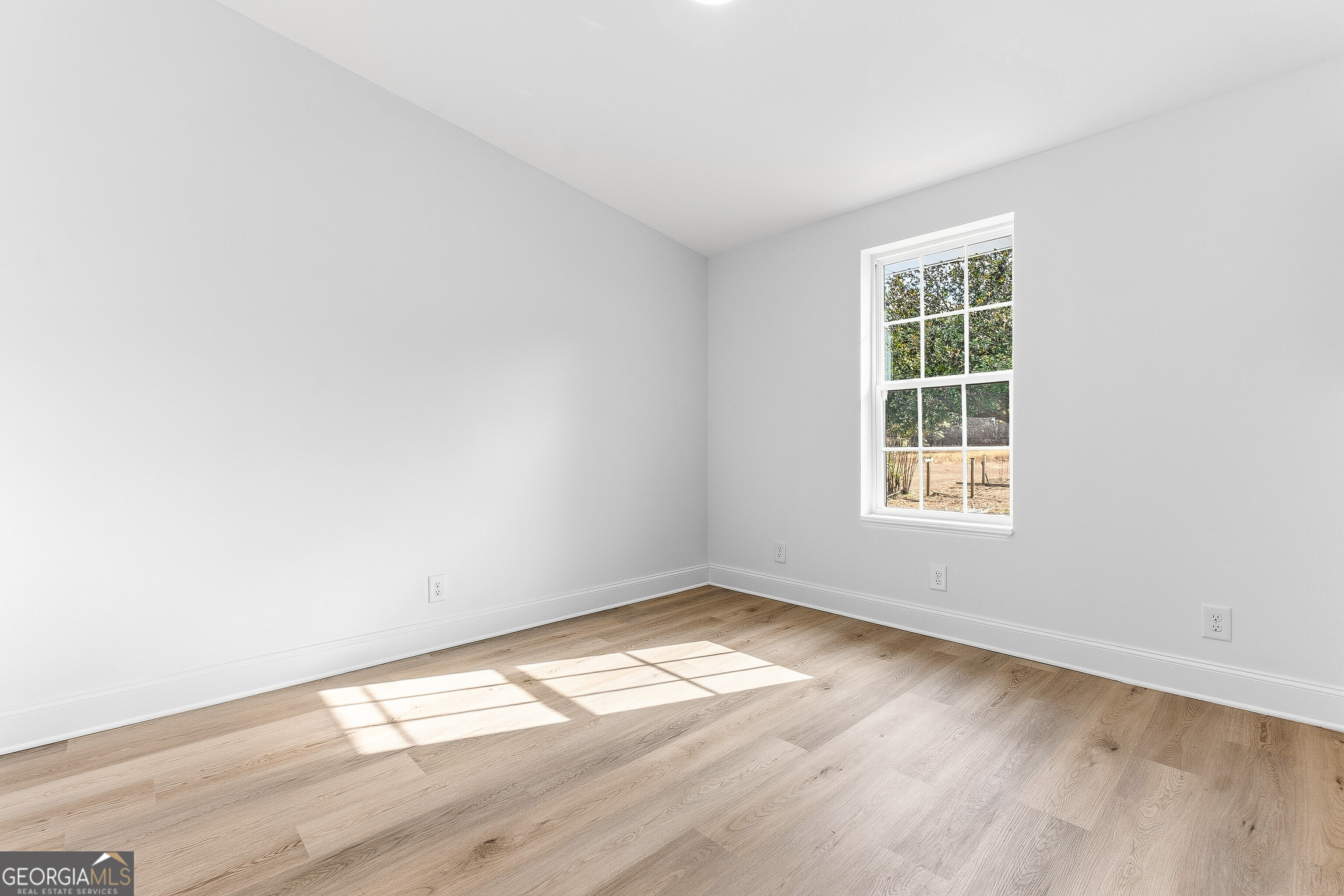 5393 Rogers Road Lizella, GA 31052 - Photo 22 of 52 an empty room with wooden floor and windows