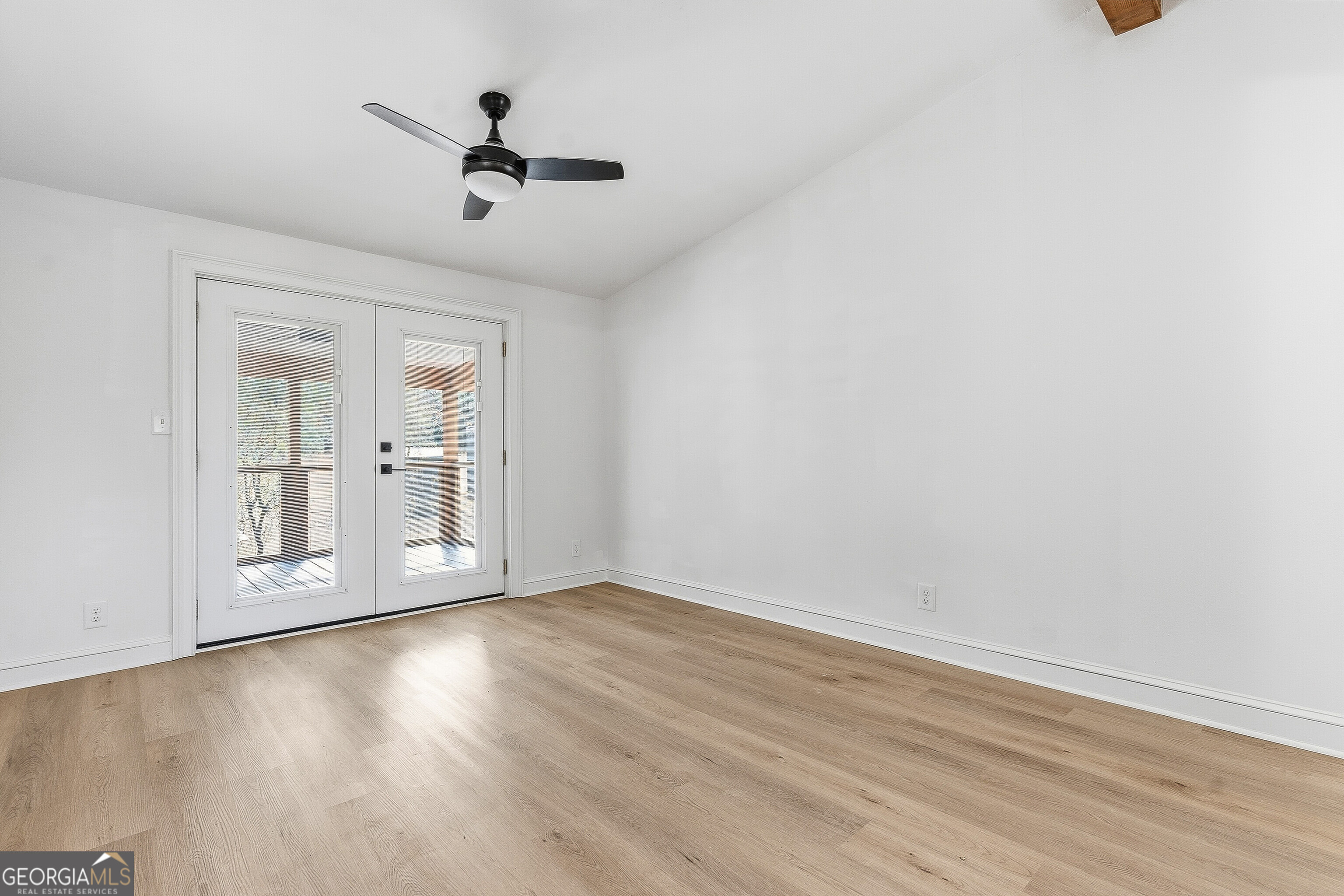 5393 Rogers Road Lizella, GA 31052 - Photo 31 of 52 an empty room with wooden floor and windows