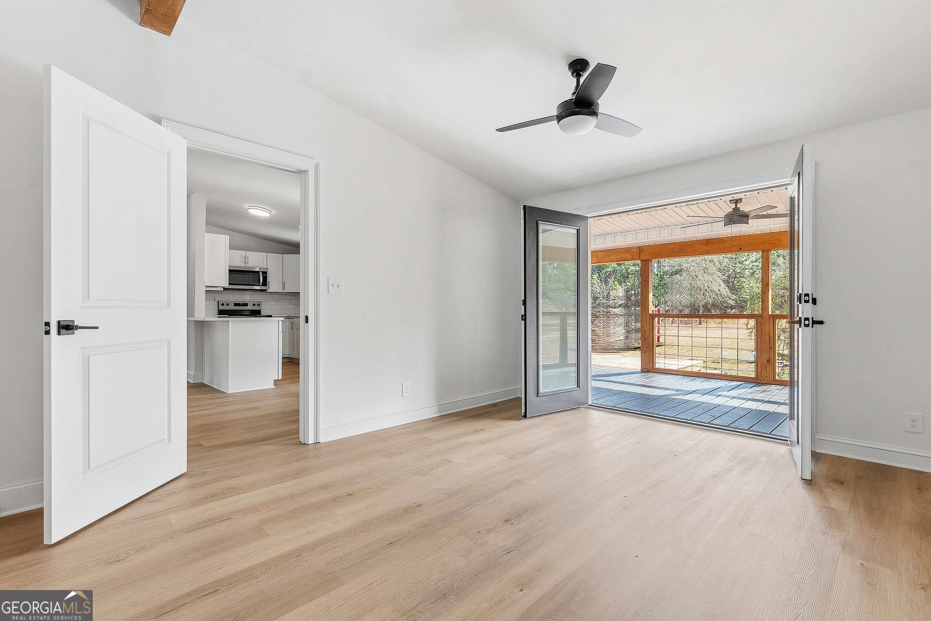 5393 Rogers Road Lizella, GA 31052 - Photo 32 of 52 a view of an empty room with a window and wooden floor