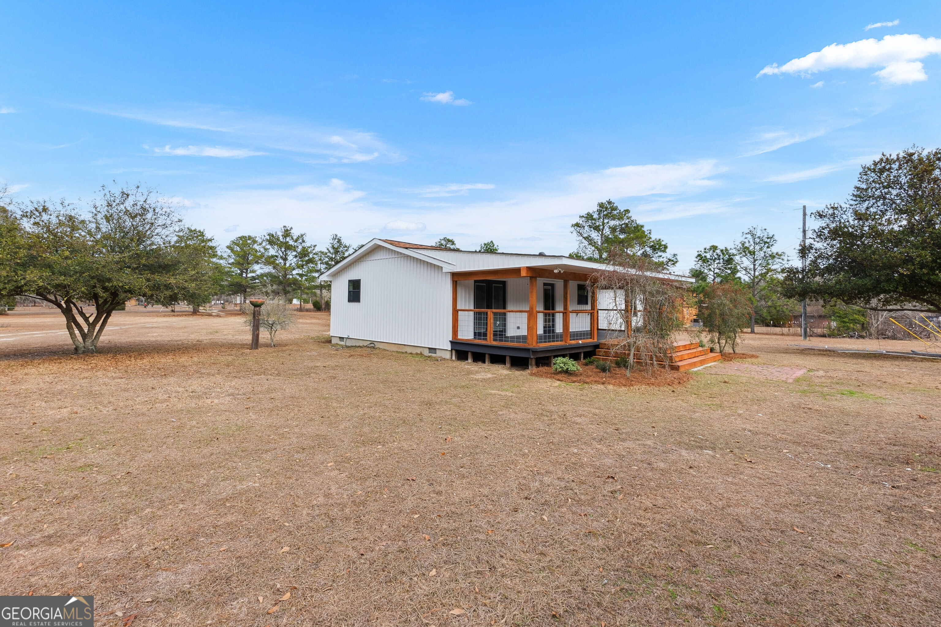 5393 Rogers Road Lizella, GA 31052 - Photo 39 of 52 a view of a house with backyard and a tree