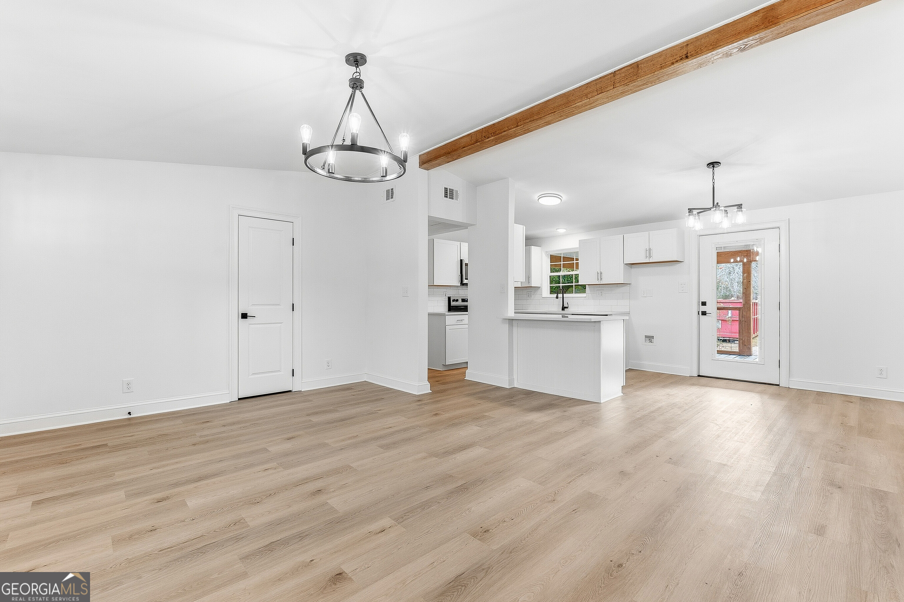 5393 Rogers Road Lizella, GA 31052 - Photo 5 of 52 a view of a kitchen with a sink dishwasher white cabinets and wooden floor